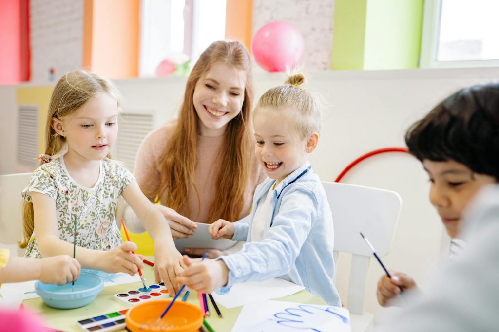 children learning to paint with water color